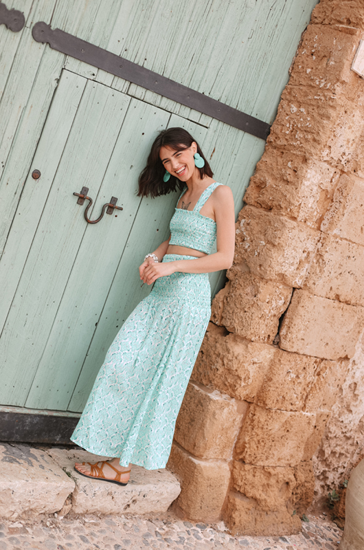 Side‑back view of high-waist skirt with scalloped hem and geometric stitch motifs