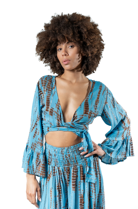 Back view of the sky blue and rust tie-dye lurex set, showing the drape and flow of the wide-leg pants.