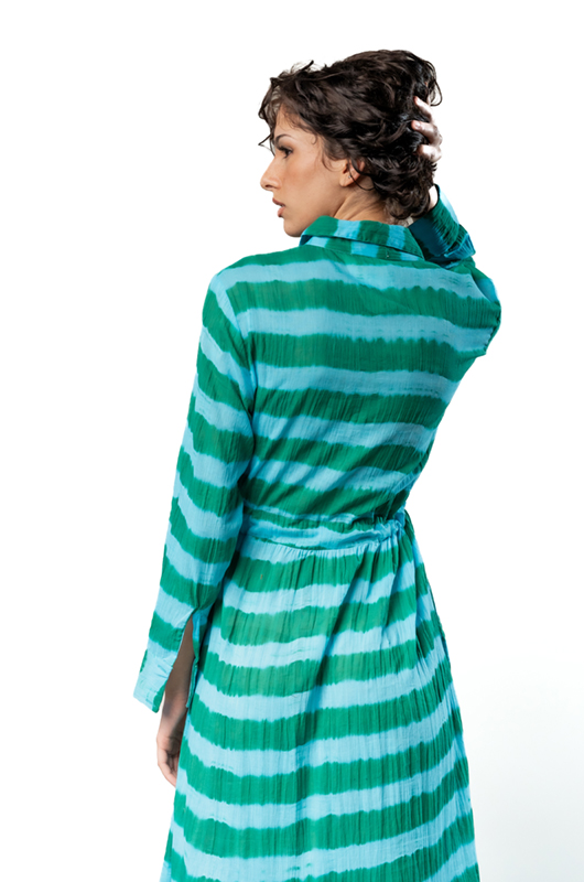 Close-up back view of a green striped shirt dress, showing details of the waist tie and fabric texture.