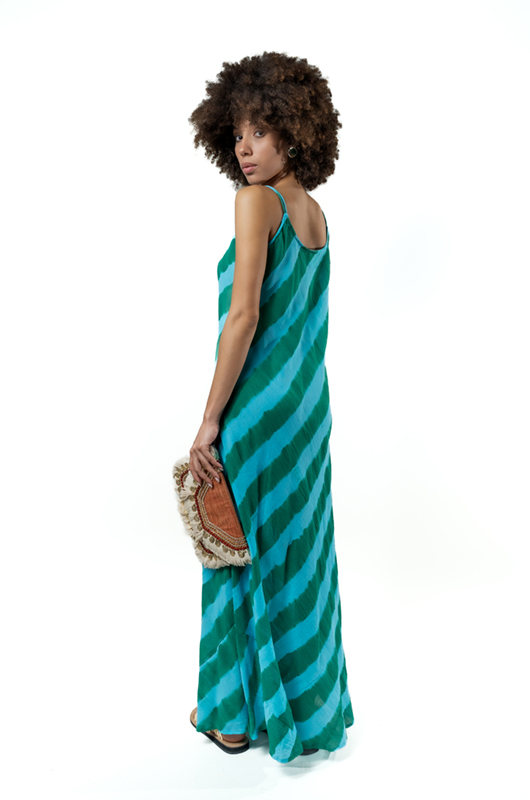 Over-the-shoulder pose revealing the back and movement of the dress.