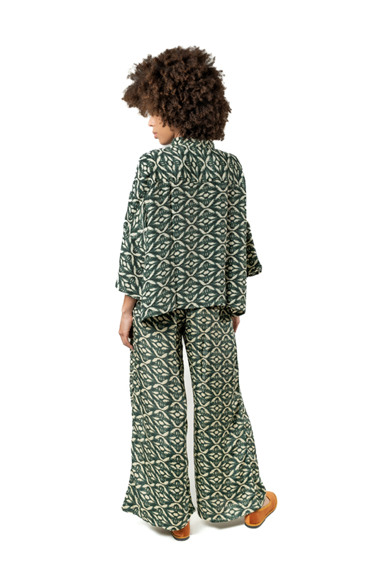 The same model turned slightly to the side, showing the back of the green printed co-ord set.