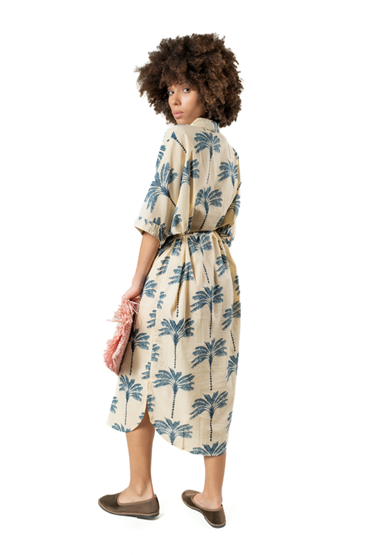 Back view of the blue palm tree print dress, showing the tied waist and relaxed fit.