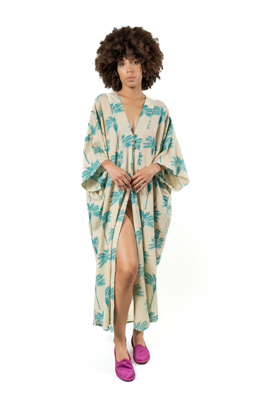 Front slit detail of beige palm print kaftan, showing lightweight and breezy fabric.