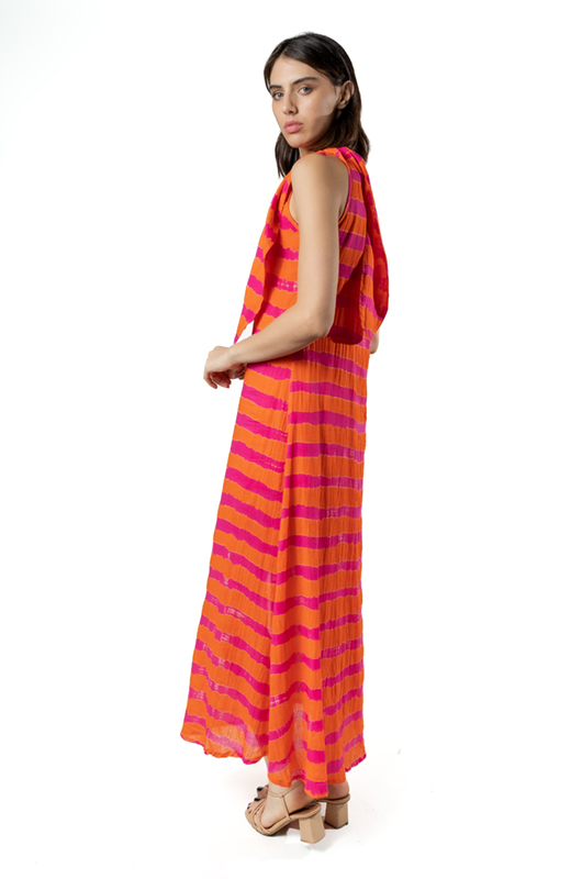 Side view showing the loose drape and length of the orange and fuchsia striped dress.