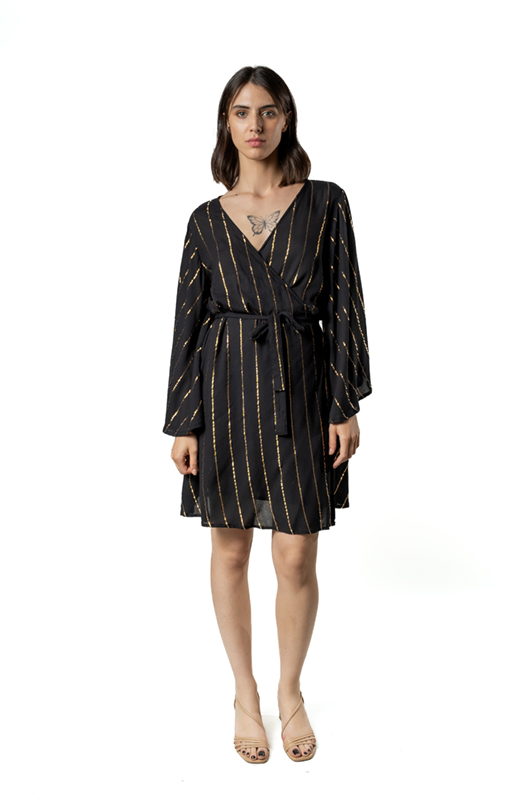 A model wearing a black wrap dress with golden diagonal stripes, posing front-facing with a calm expression.