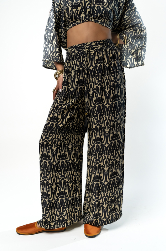 Close-up of patterned wide-leg pants, showing details of the fabric design.