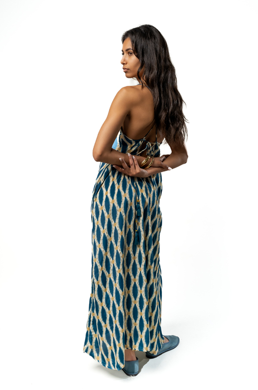 Back view of the same dress showing criss-cross tie details and an open back design.