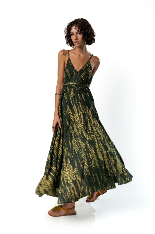 "Model wearing a sleeveless dark green and yellow tie-dye maxi dress with a fitted waist and flowing skirt."