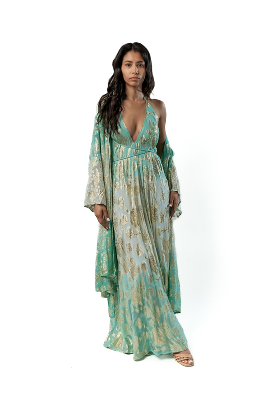Model wearing a turquoise and gold metallic halter maxi dress with a matching long kimono layered over the shoulders.