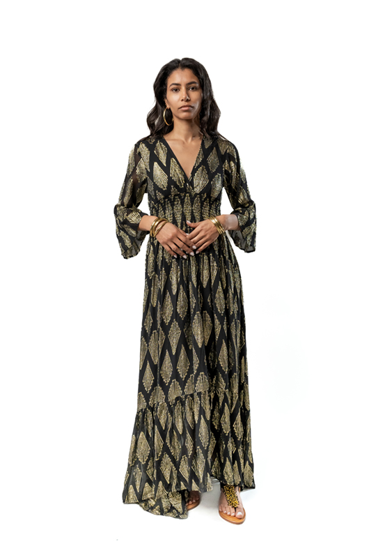 Front view of a black maxi dress with gold geometric leaf patterns, V-neckline, and long flared sleeves.