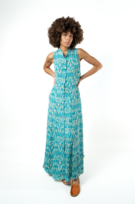 leeveless turquoise blue maxi dress with abstract ikat print, side-front pose with pockets.