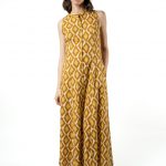 leeveless mustard yellow maxi dress with diamond print, front buttons, and pockets, modeled from the front.