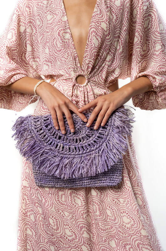 Close-up of the beige palm-print dress highlighting a round cut-out at the waist with gathered fabric and tassel-tied strings.
