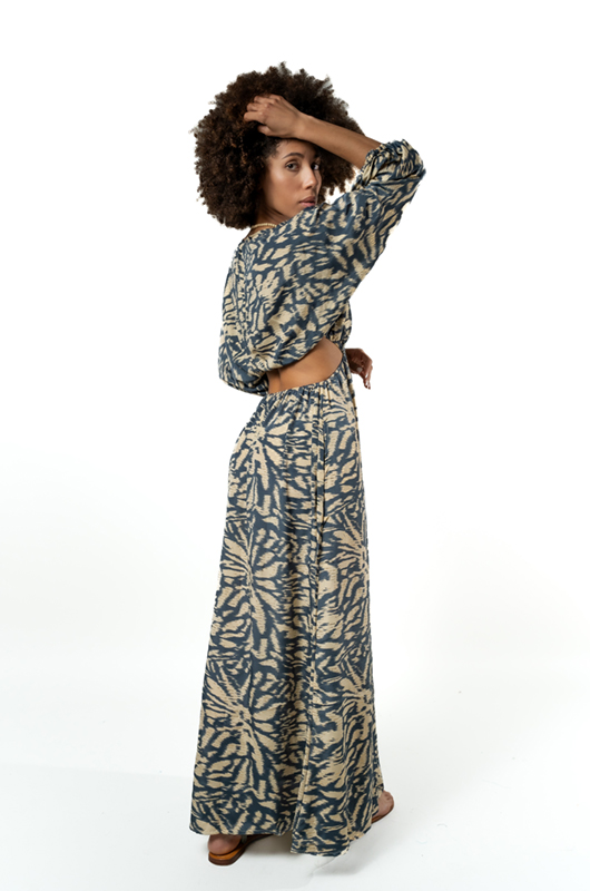 "Back view of a grey patterned maxi dress featuring an open back design with loose long sleeves."